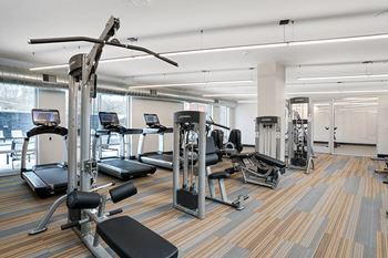 Fitness center with Peloton bikes and yoga room